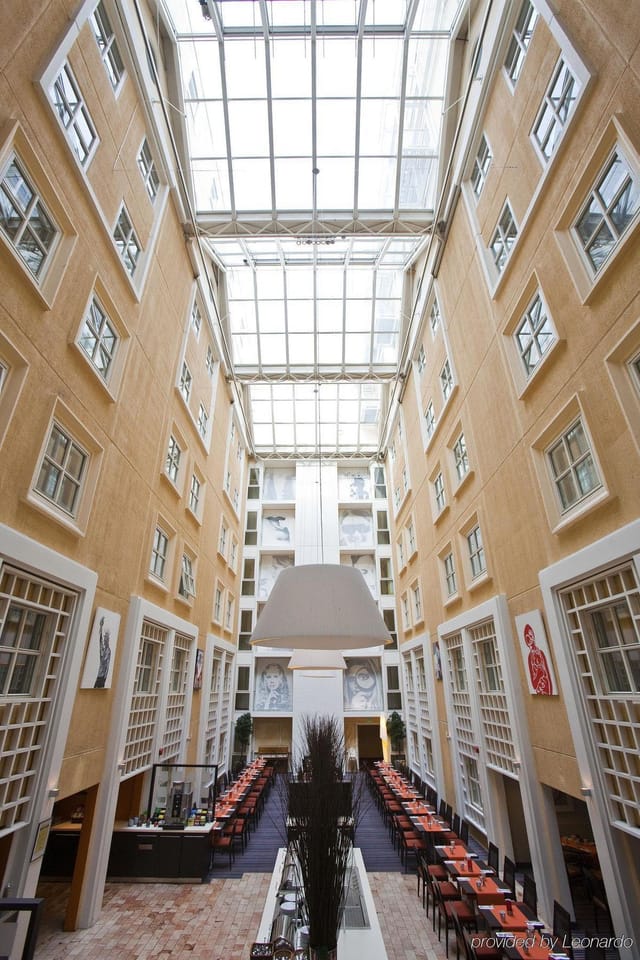 Scandic Victoria Oslo sunlit hotel atrium for corporate networking and registration events.
