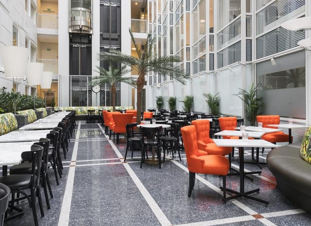 Thon Hotel Cecil atrium with café seating, perfect for networking events and corporate breakouts.