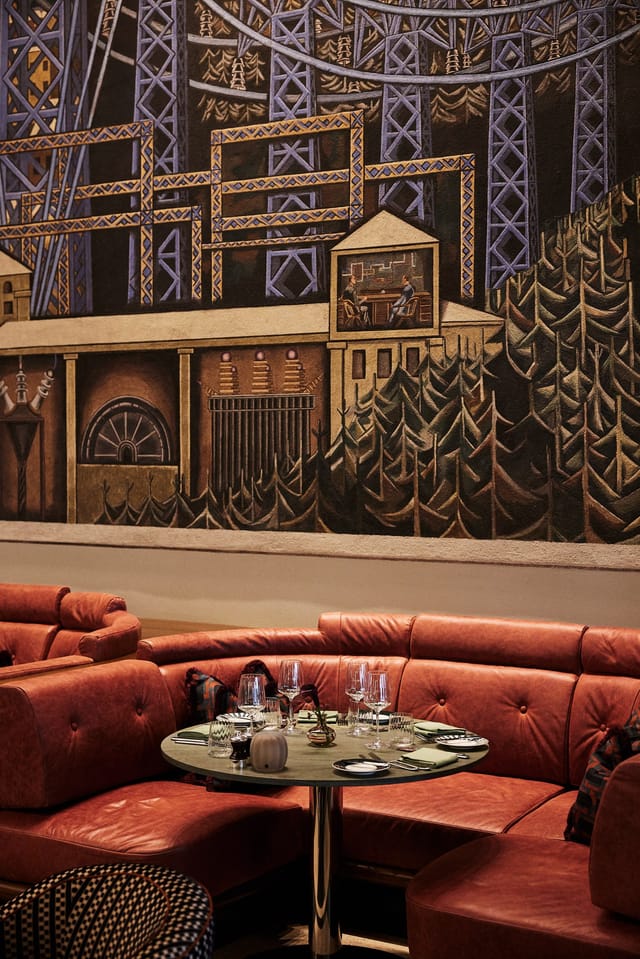 Sommerro cafe with statement mural and curved leather seating for corporate event venue.