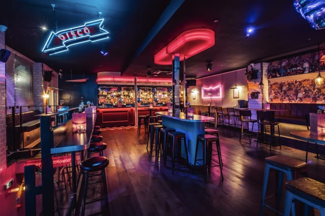 Vibrant nightlife venue hire in Shoreditch with neon bar for parties and mixers.
