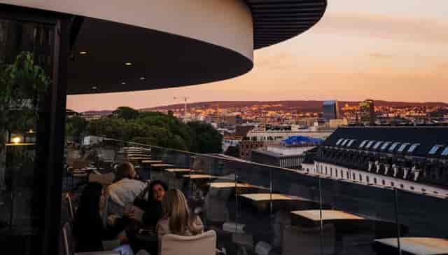 TAK Oslo rooftop venue with sunset skyline views for corporate networking and premium events.