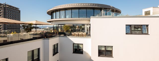 TAK Oslo rooftop venue with circular architecture for corporate receptions and evening mixers.