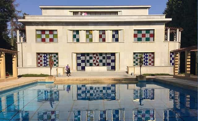 Villa Empain gala venue with symmetrical waterfront facade for luxury corporate events.