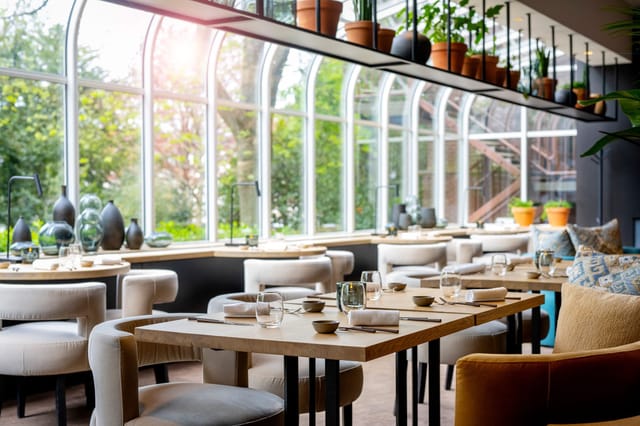 Upscale restaurant with biophilic design for networking luncheons and corporate breakout sessions.