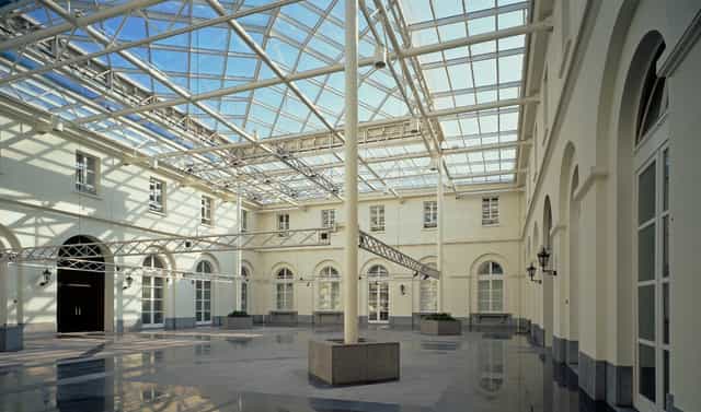 Palais des Académies atrium, high-end architecture, ideal for gala receptions and event registration.
