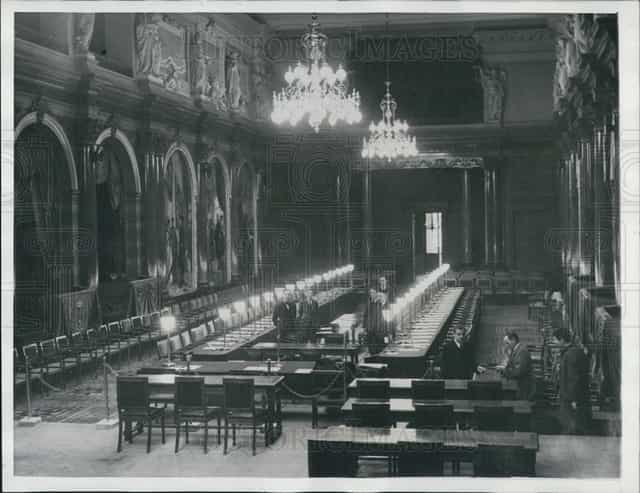 Formal long-table banquet setup in Palais des Académies conference center for corporate events.