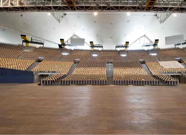 Olympiahalle arena with tiered seating for trade shows and plenary sessions.