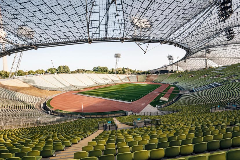 Olympiahalle stadium interior with iconic architecture for large-scale events and plenary sessions.