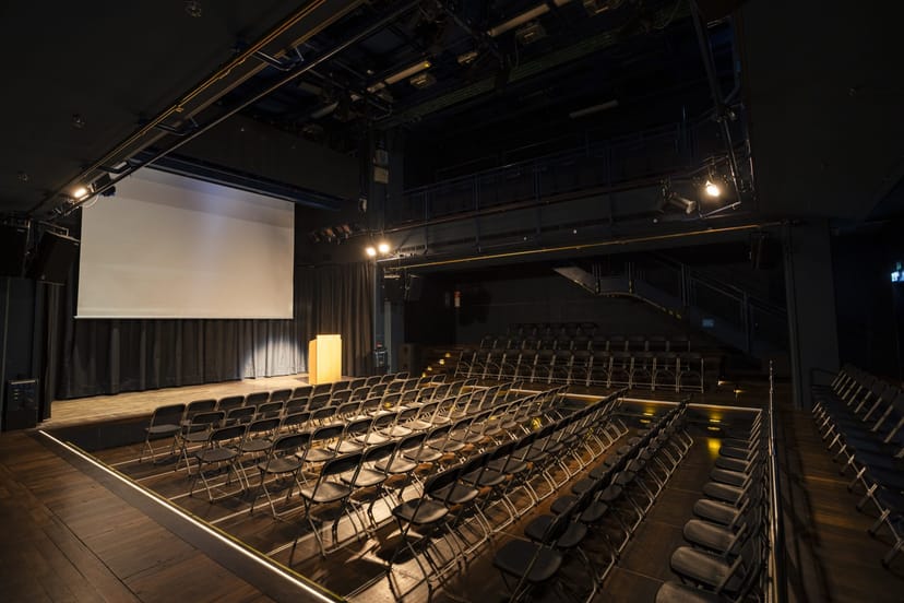 Black Box Gasteig theater-style event space with podium for professional plenary keynote sessions.