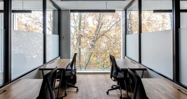 Minimalist office breakout space for one-on-one strategy sessions and intimate business meetings.