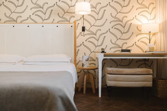 Cortiina Hotel suite with workspace for business travel and conference stays.