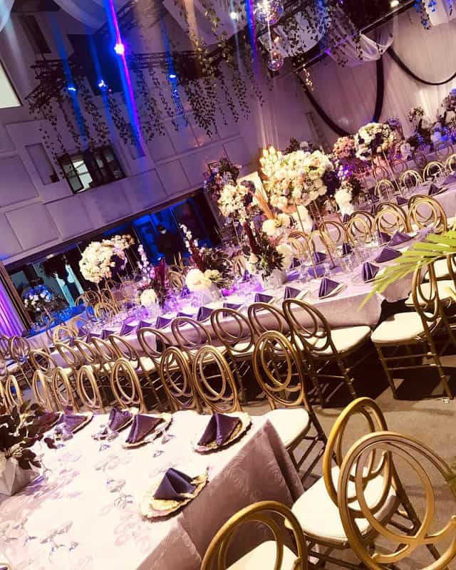 Luxury gala banquet at The NW Lounge with gold chairs and floral centerpieces for formal events.