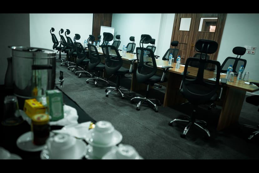 Executive boardroom at Empresa Hotel with long-table setup for corporate meetings and conferences.