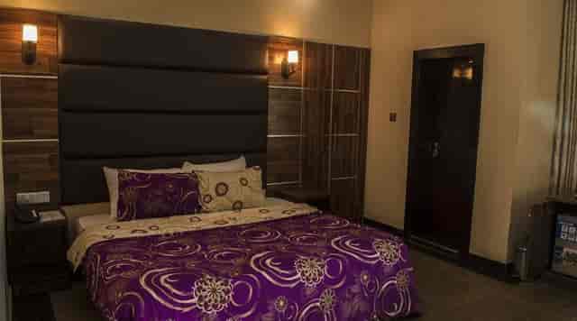 Oranmiyan Hall, Lagos Airport Hotel room with patterned bedding for corporate event bookings.