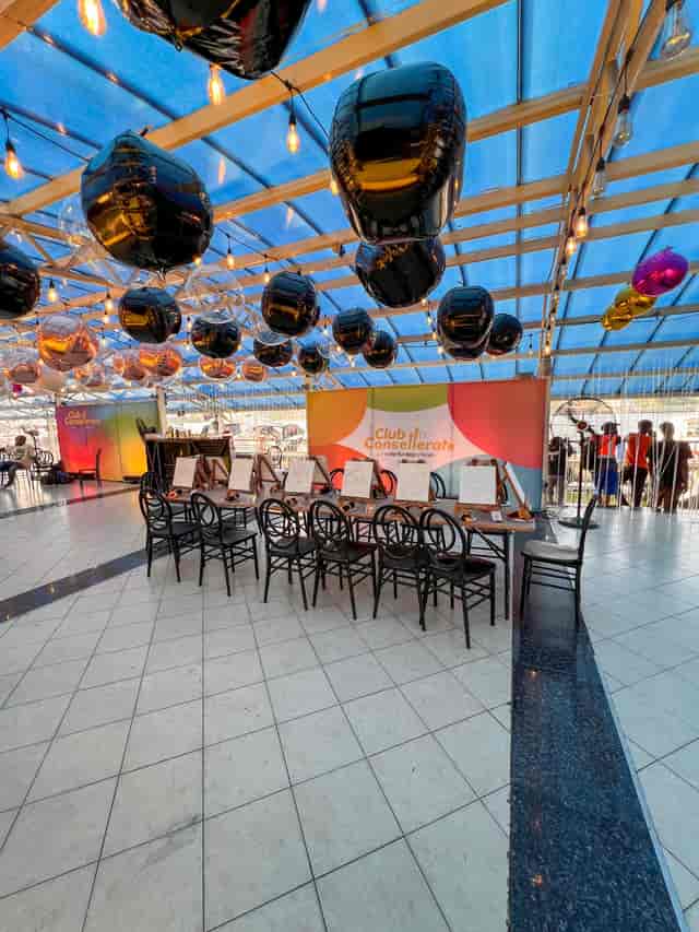 Outdoor creative workshop venue with balloon decor for branded paint-and-sip events.