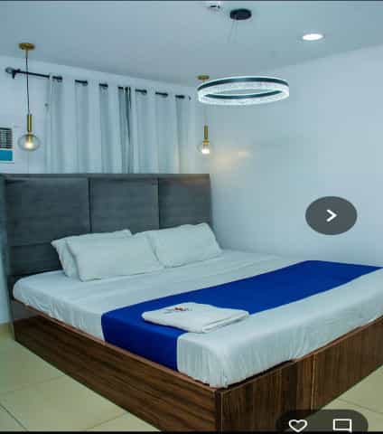 Executive Suite hotel room with minimalist lighting for business travel and event lodging.