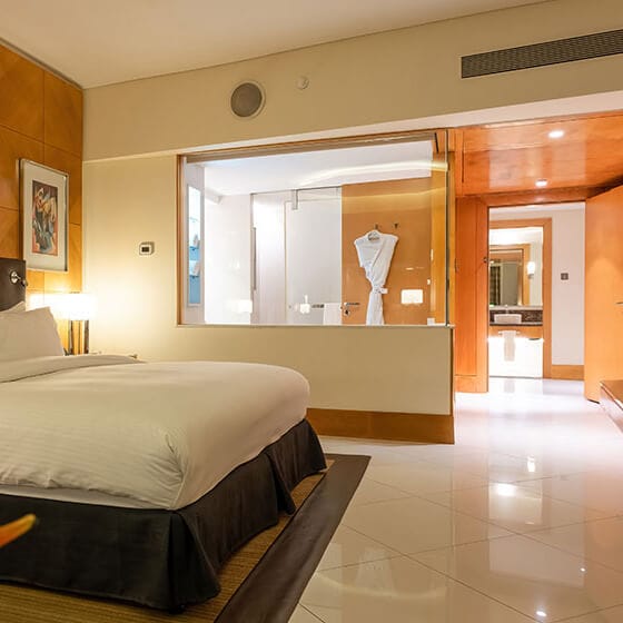 Upscale hotel suite with open-concept bathroom for luxury travel and corporate event lodging.