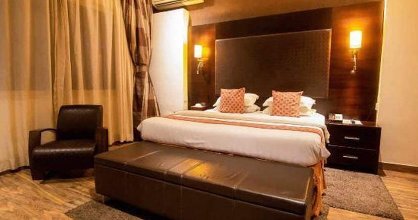 Standard hotel suite with warm lighting for corporate conference travel and business lodging.