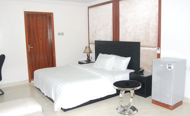 Serena Hotel & Suites business room with dated decor for corporate meetings and hotel bookings.
