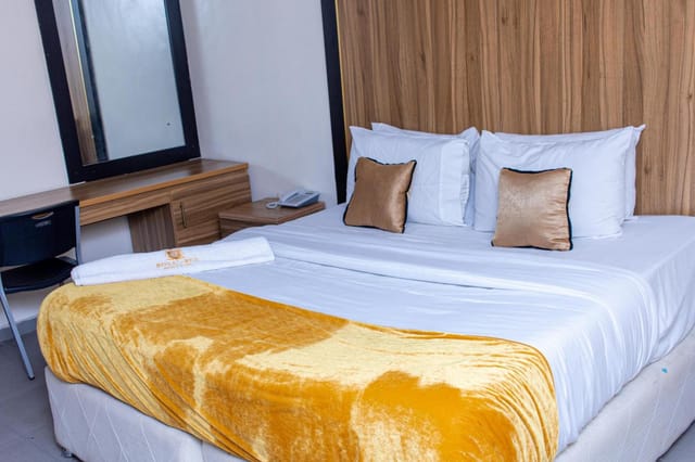 Royalrex Hotel room with dedicated workspace for business travel and conference lodging.