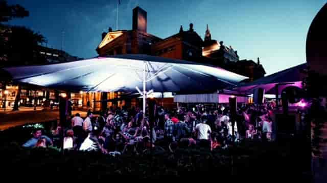 Networking event at Lawo Terrasse with outdoor structural covering. Corporate evening mixer.