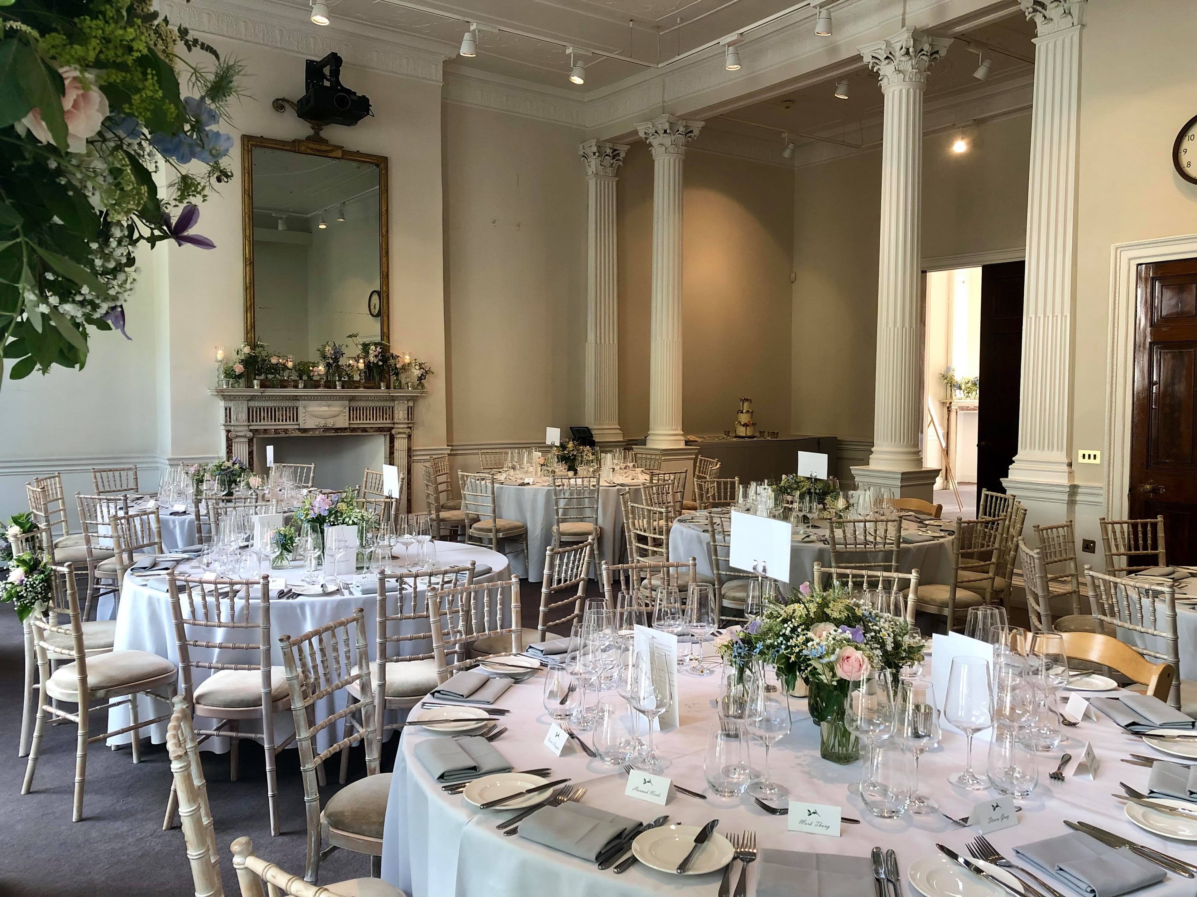 Elegant event space with round tables, perfect for weddings and corporate functions. - Banner