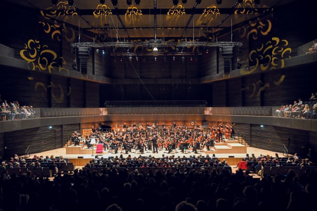Isarphilharmonie concert hall stage for large plenary sessions and keynote events.