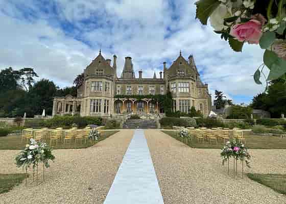 Luxury outdoor wedding ceremony at Orchardleigh House, Somerset, featuring elegant floral aisles.