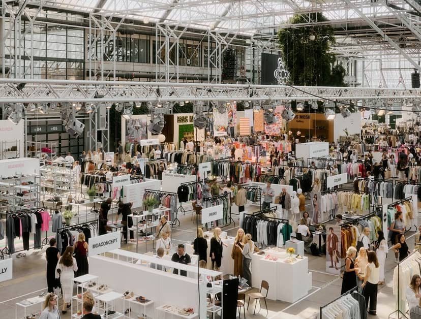 CIFF fashion trade show: industrial showroom with organized pipe-and-drape retail displays.