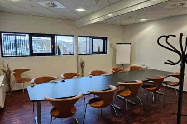 Boardroom setup at Royal Conference featuring organized seating for corporate meeting events.