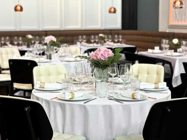 Banquet hall in TERRASSEN with round tables and stylish seating for corporate dinners and events.