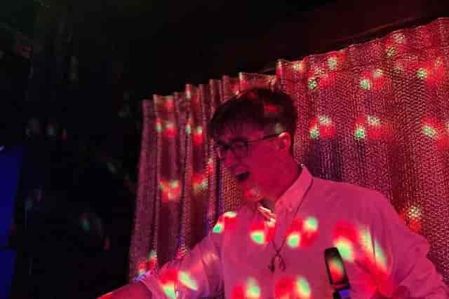 DJ performing with ambient lighting at 4Tallet Live corporate event entertainment.