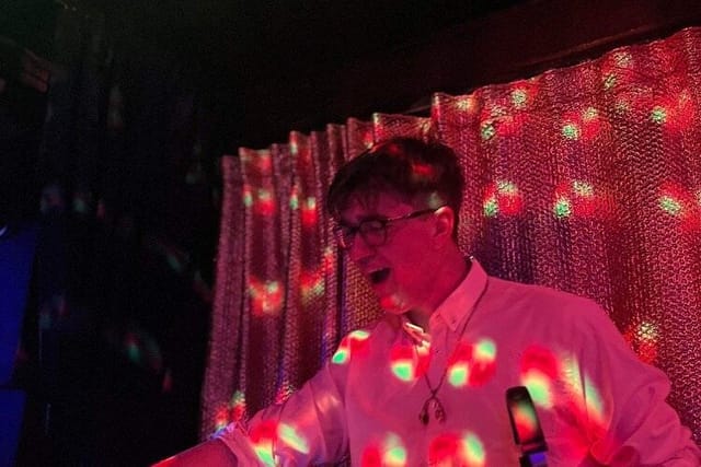 DJ performing with ambient lighting at 4Tallet Live corporate event entertainment.