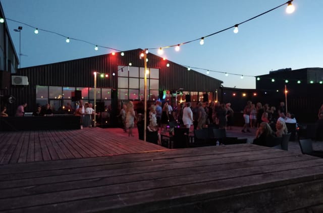 Industrial-chic outdoor venue at Terminal13 with festoon lighting for networking and social events.