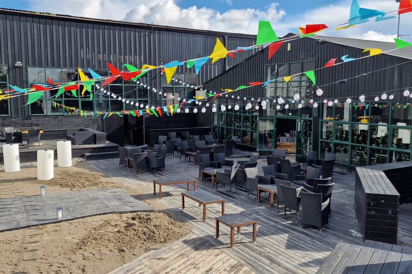 Industrial-chic outdoor venue with festoon lighting for networking and corporate events.