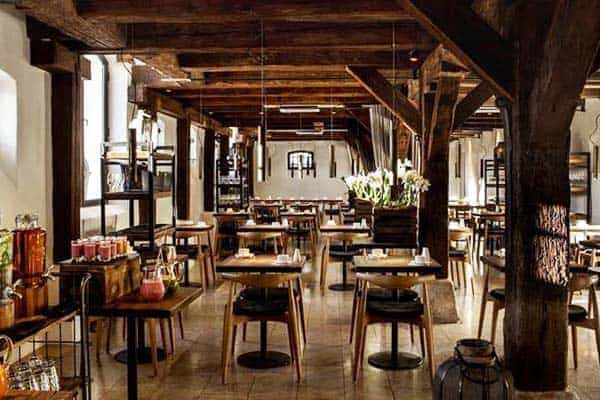 Rustic-industrial bar at 71 Nyhavn Hotel featuring timber beams for intimate event coffee breaks.