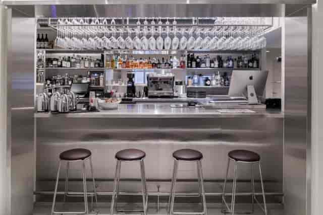 Modern stainless steel bar at Hotel Ottilia for corporate networking and happy hour events.