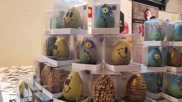 Artisanal Easter eggs on tiered retail display for corporate event or seasonal activation.