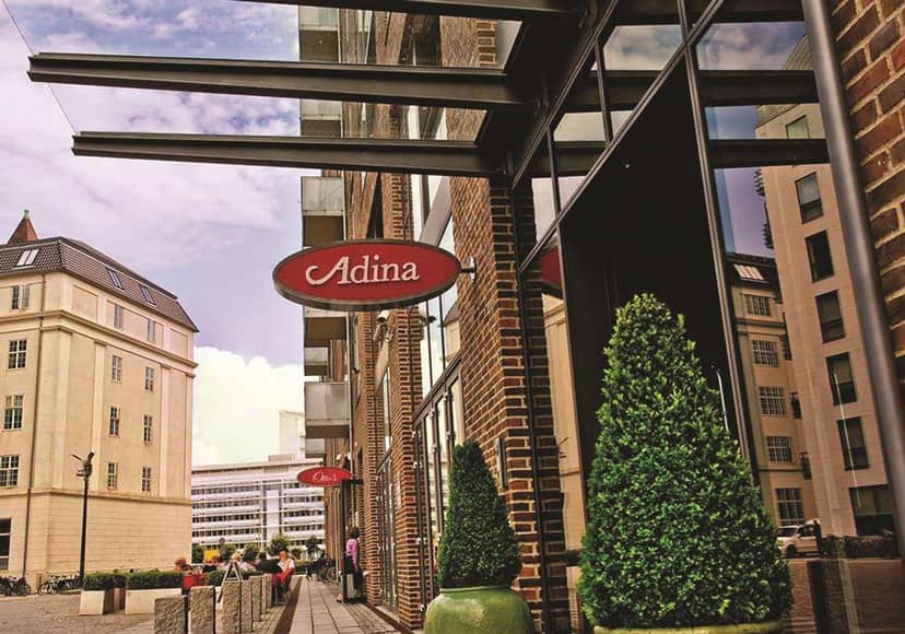 Adina Apartment Hotel Copenhagen entrance, modern street-level venue for corporate meetings.