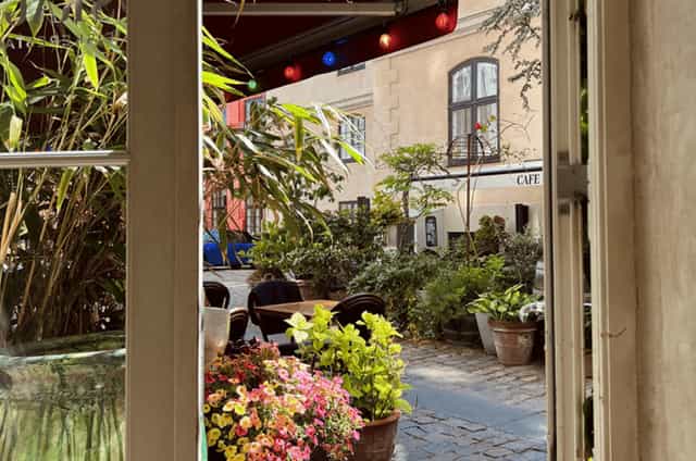 Courtyard terrace with bistro seating for networking events and boutique meetings.