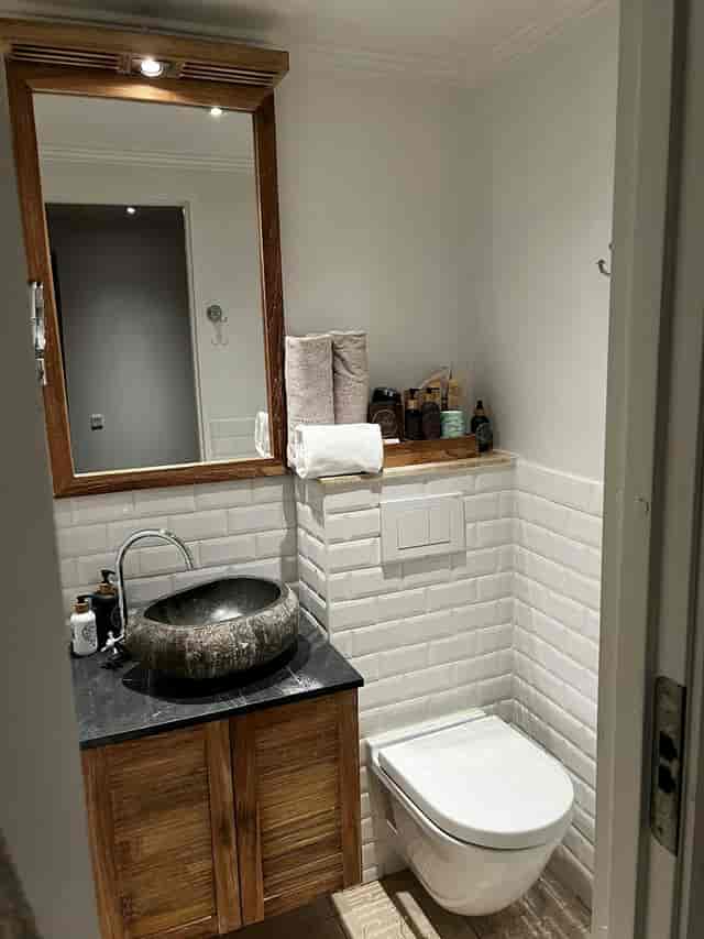 Luxury hotel restroom with stone sink, ideal for upscale events and boutique meeting venues.