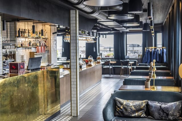 Brass-accented hotel bar for corporate networking and high-end evening mixers.