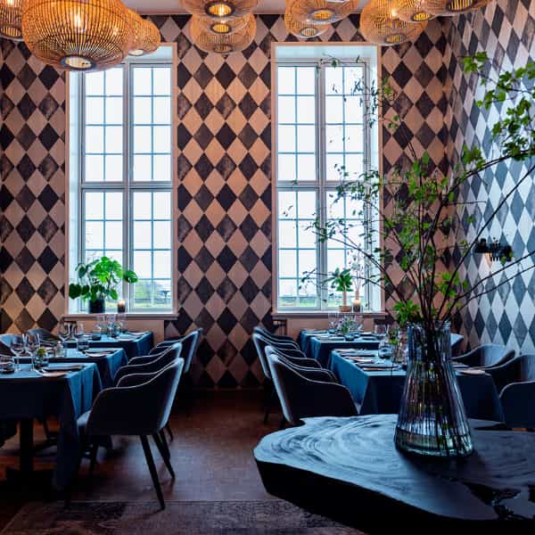 Elegant Rungstedgaard restaurant with harlequin wallpaper for executive dinners and networking.