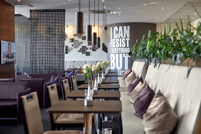 Modern Bar in The Square lounge with high-backed seating for networking and business events.
