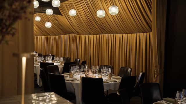 Private dining banquet hall with pendant lighting for executive dinners and VIP events.