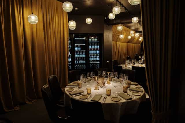 Private dining banquet hall with round table for intimate events and luxury party venue.