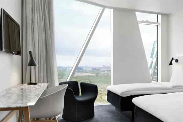 Minimalist executive meeting room with natural light for corporate events and VIP business stays.