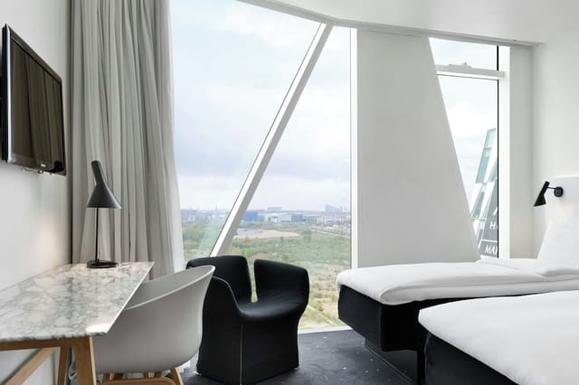 Minimalist executive meeting room with natural light for corporate events and VIP business stays.