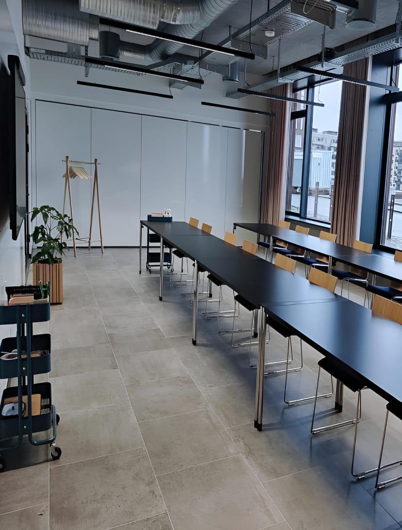 Minimalist CodeNode conference room with classroom seating for professional training events.