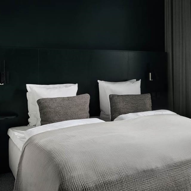 Minimalist Hotel Hans executive suite: moody aesthetic for upscale corporate room blocks.